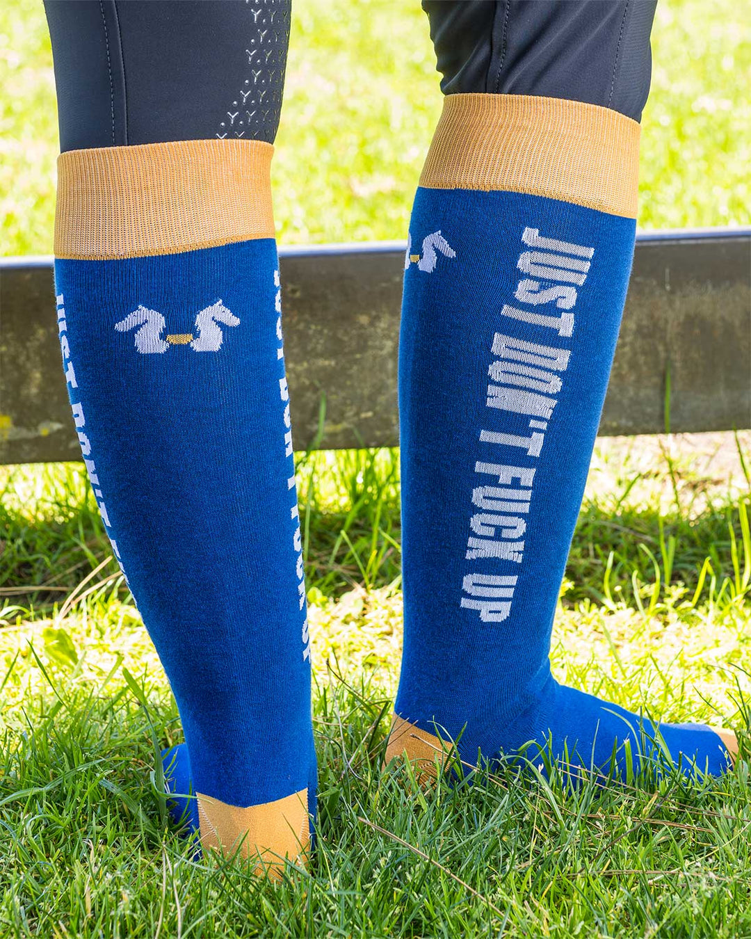 Blue Socks featuring Karl Cook’s bold JDFU saying, perfect for riding boots and equestrian style.
